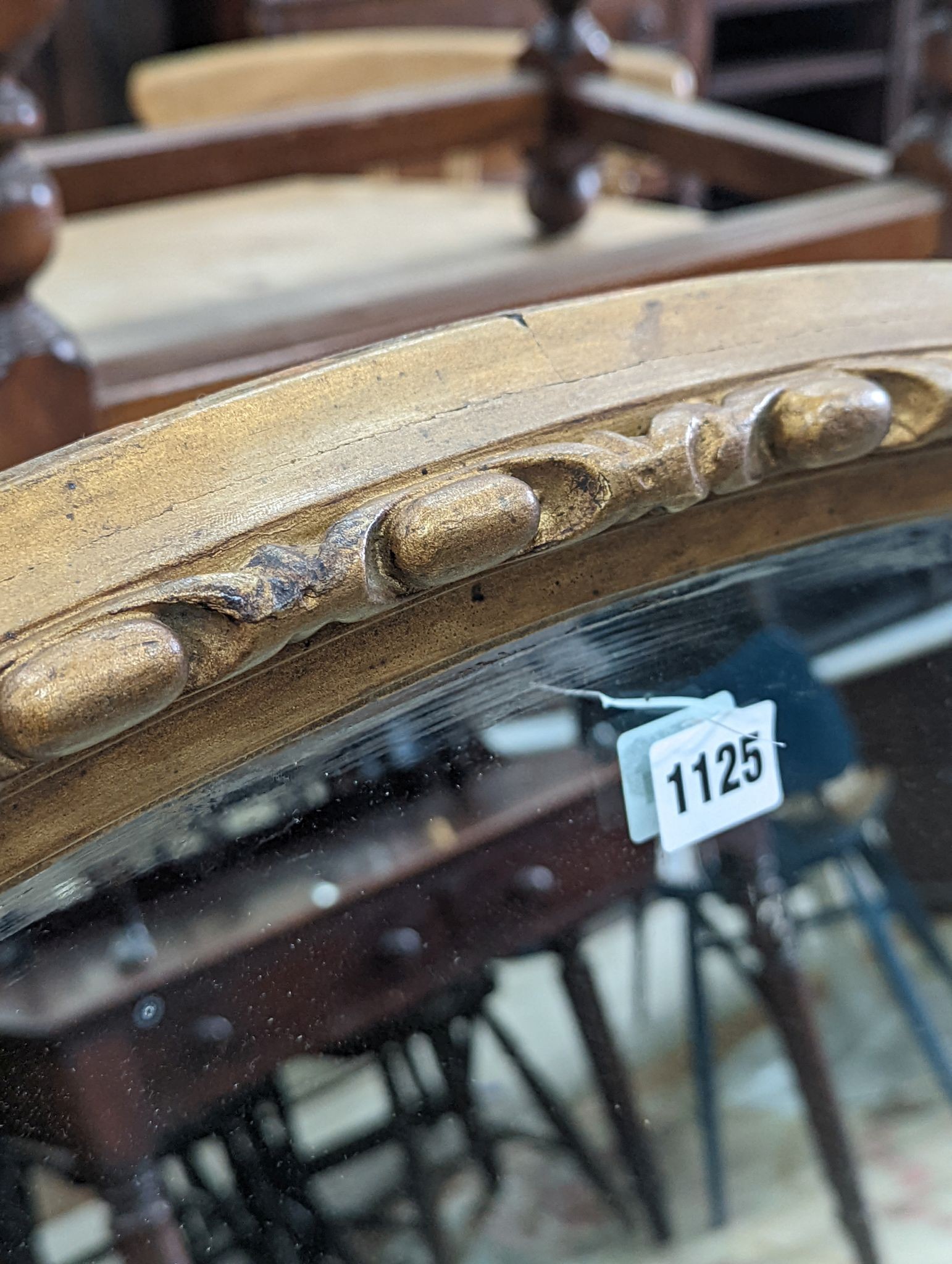 An early 20th century carved gilt oval wall mirror, width 110cm, height 80cm